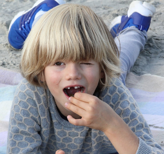 little boy eating blackberries