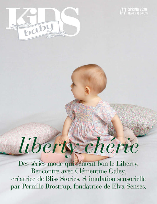 Baby Kids magazine cover baby sitting on a blanket