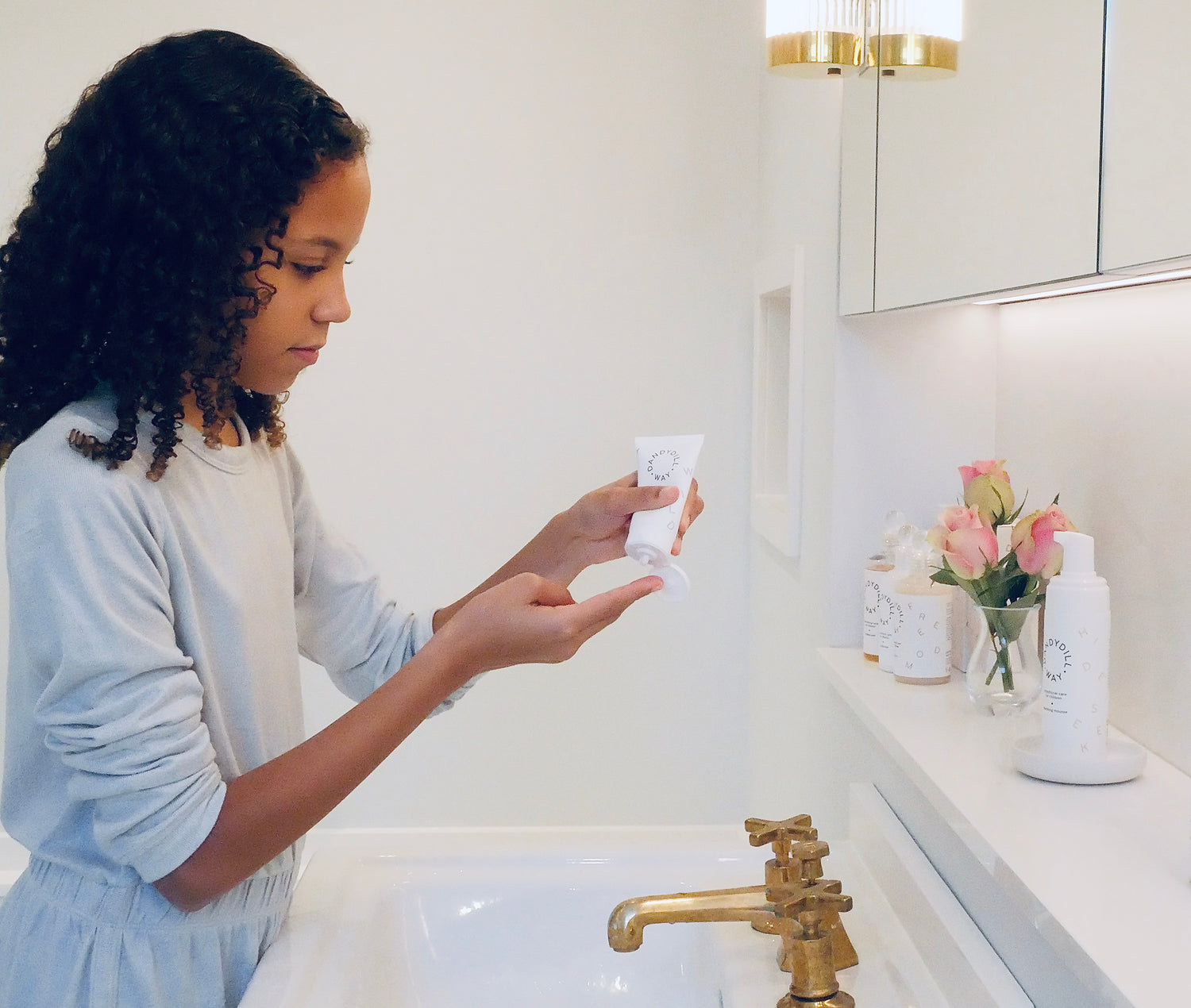 Girl applying hyaluronic acid moisturiser for kids sensitive skin