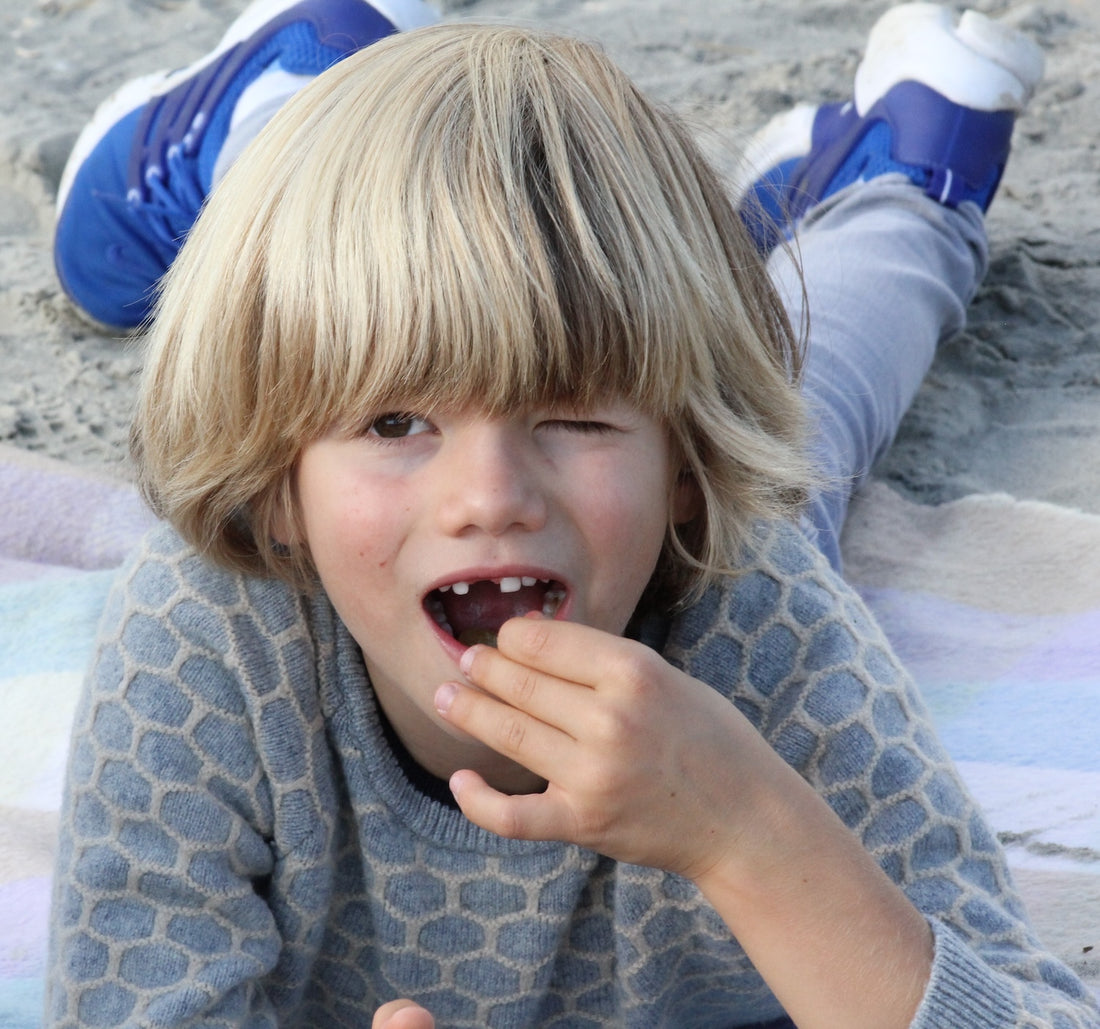 little boy eating blackberries 
