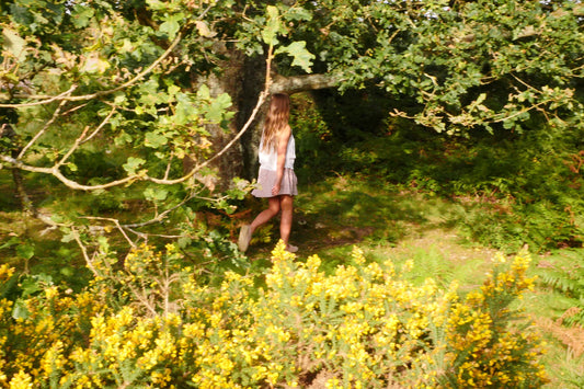 child running through sunlit woodland