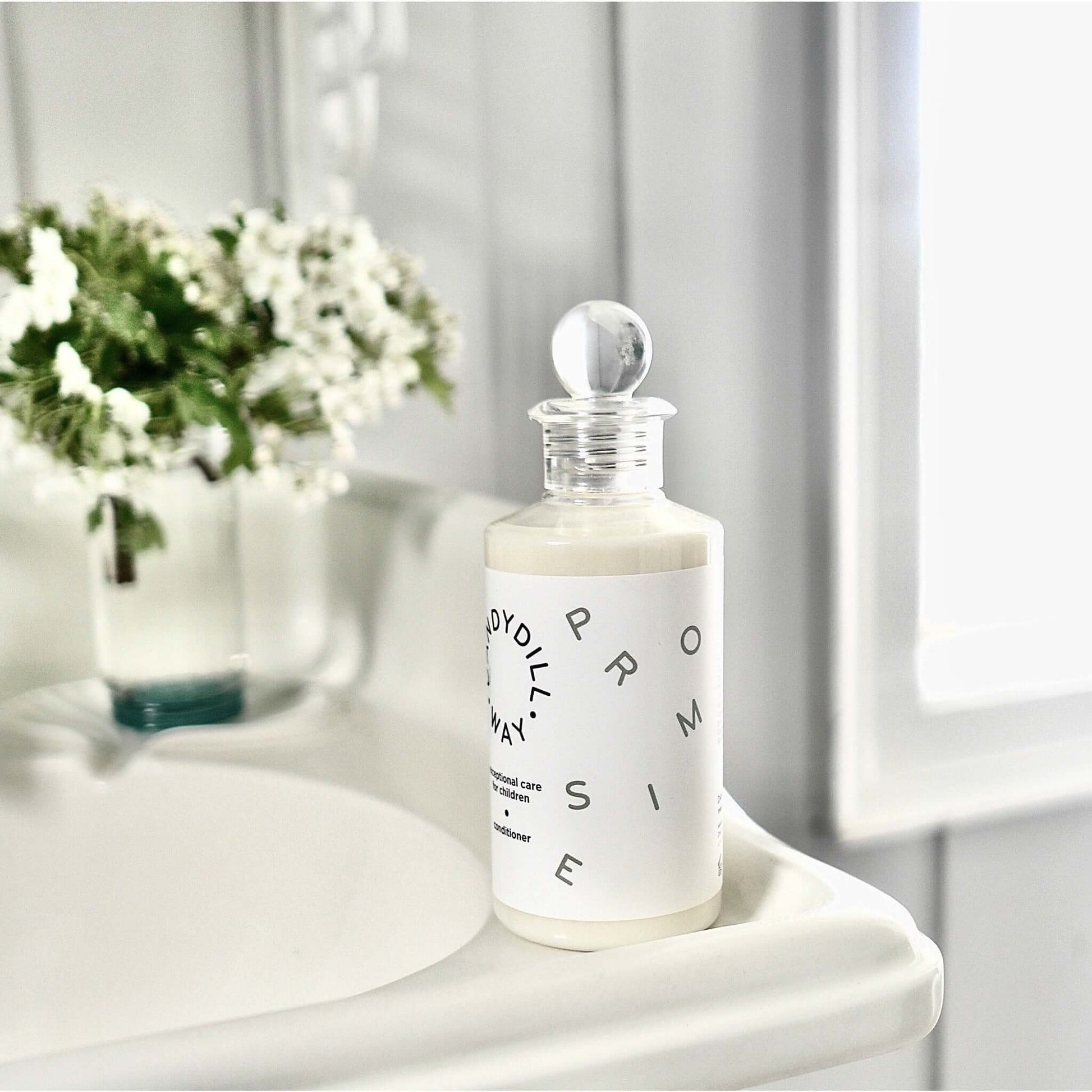 Wild Hawthorn Berry silicone free Hair Conditioner bottle with white hawthorn blossom on antique sink.