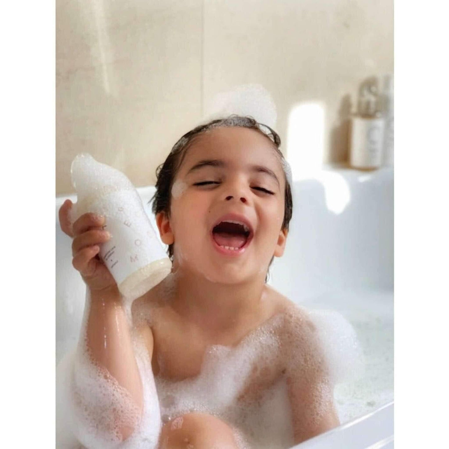Young boy laughing with SLS Free Wild Hawthorn Berry Shampoo